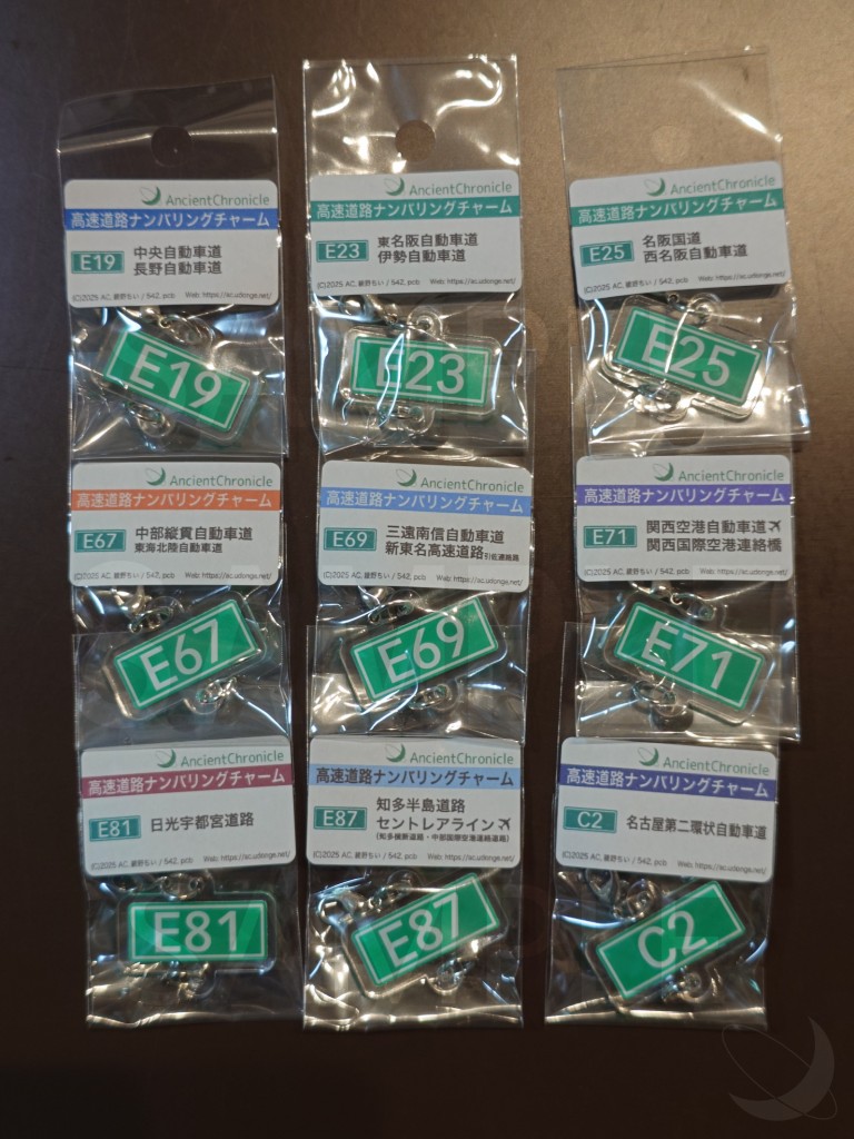 [チャームのサンプル。左上から右に3つずつ、E19、E23、E25、E67、E69、E71、E81、E87、C2のナンバリングがデザインされたチャームが載っている
